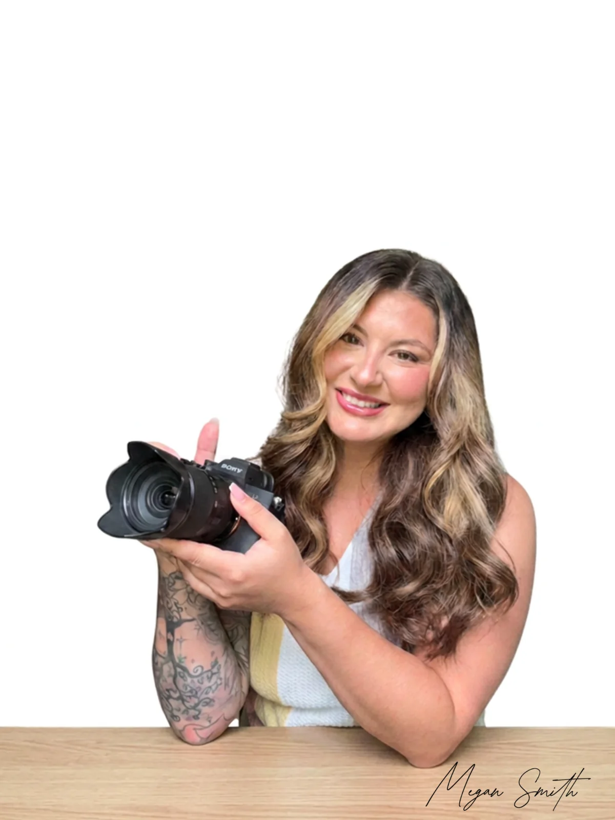 Megan Smith smiling while holding her camera